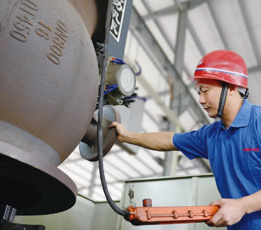 Technician operating a large valve at the plant